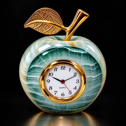 Green onyx apple clock with gold-tone leaf on black background